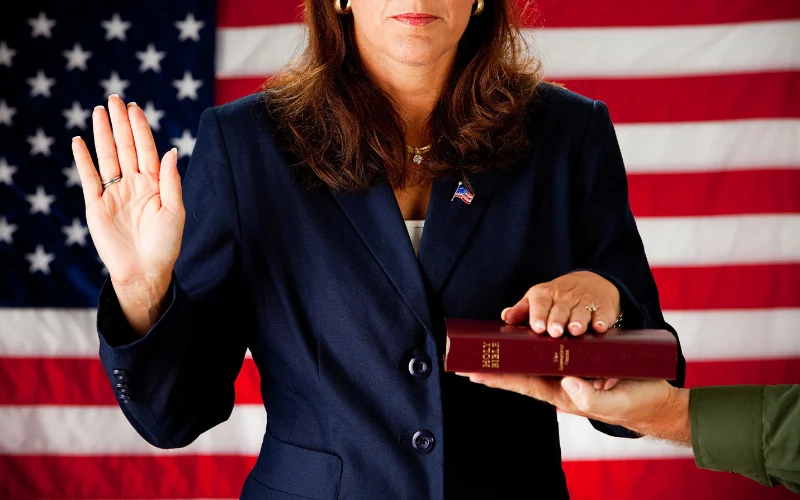 ocrc_politician_woman Woman politician taking the oath of office with hand on a bible